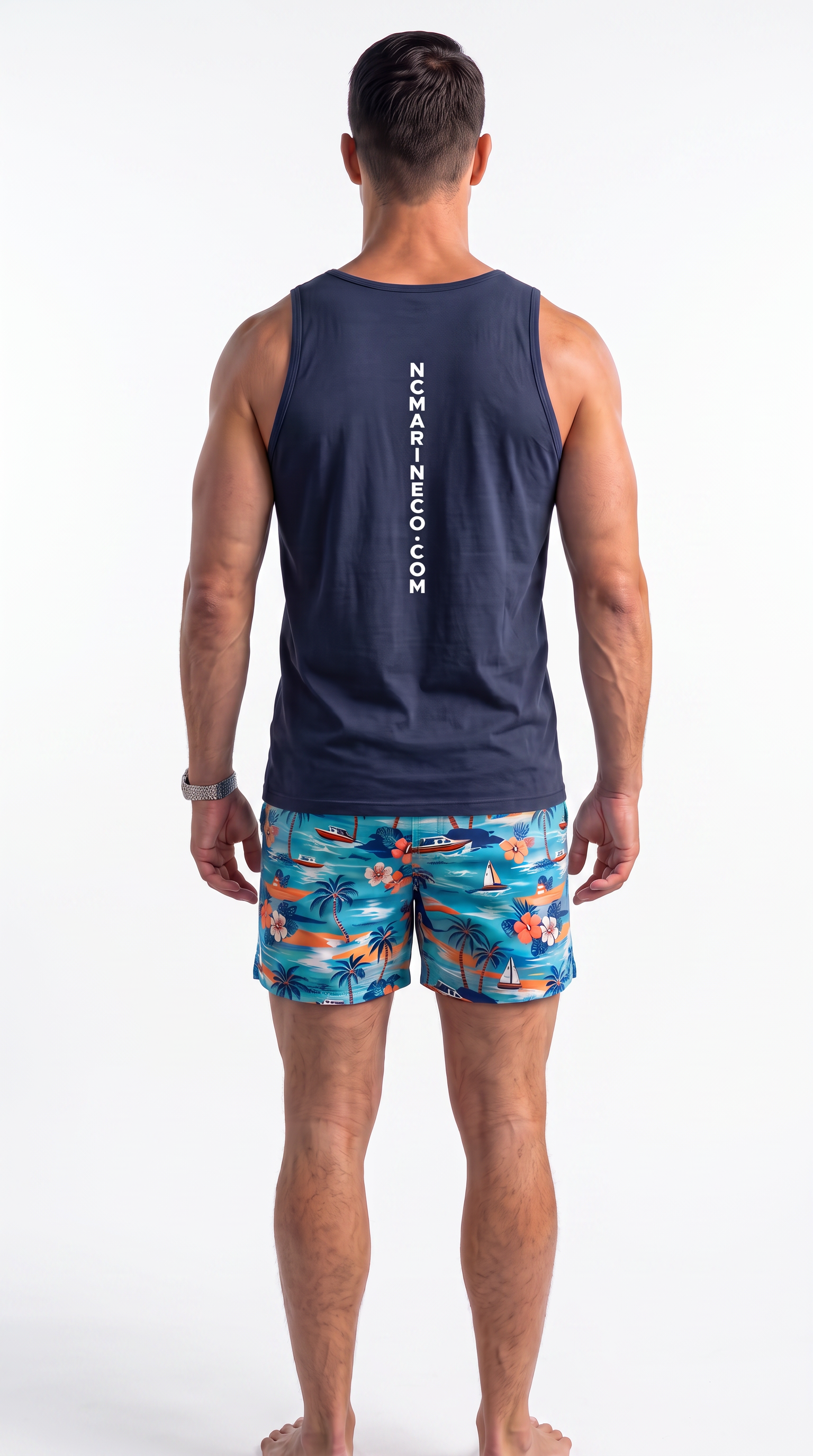 A man viewed from behind wearing a navy blue tank top with vertical white 'NCMARINECO.COM' text on the back and colorful tropical print swim trunks, against a plain white studio background.